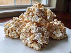 A stack of four homemade avalanche cookies made with cereal, peanut butter, and white chocolate chips.
