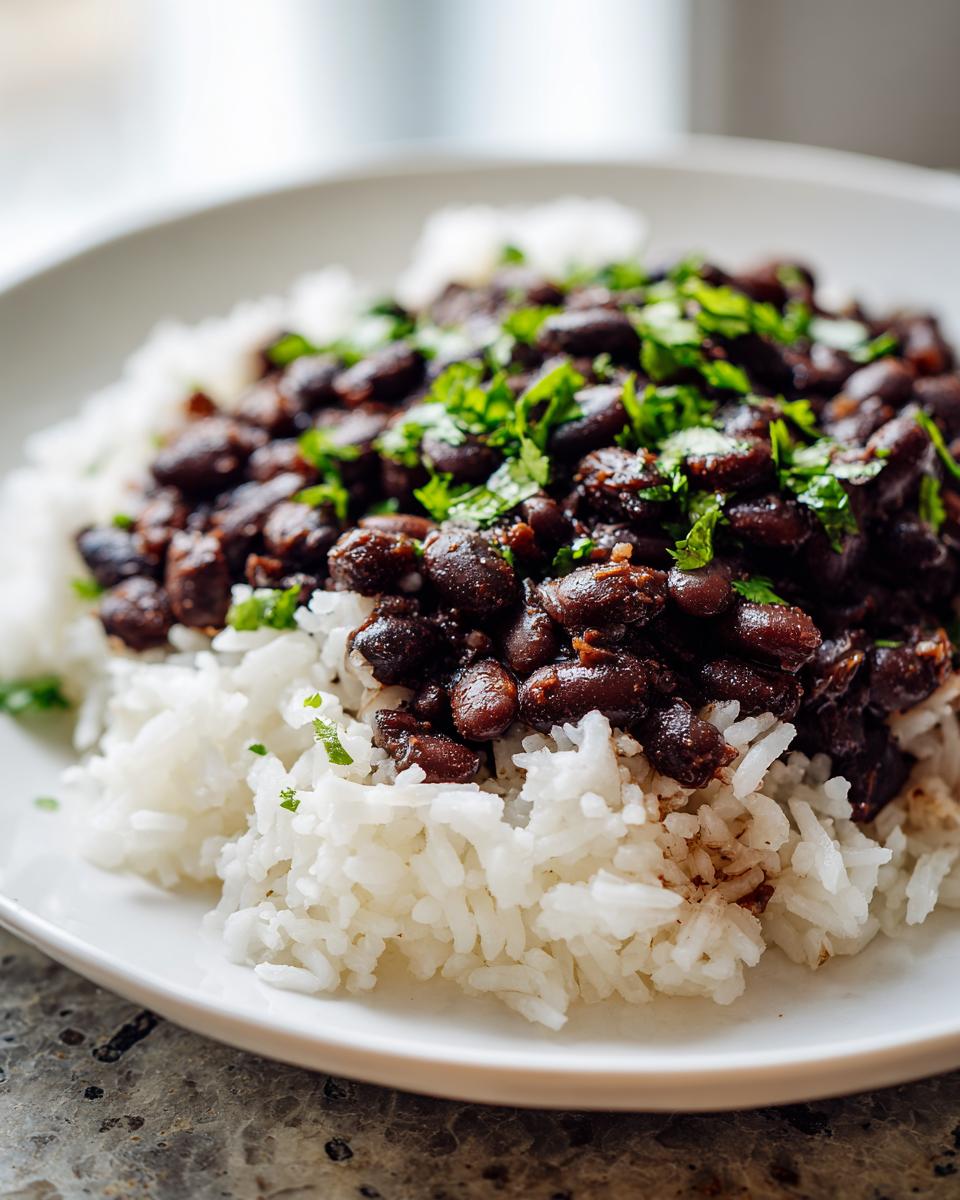 A close-up serving of flavorful beans and rice topped generously with fresh chopped cilantro.
