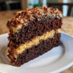 A moist slice of dark chocolate cake with coconut-pecan frosting, central to the german chocolate cake recipe.