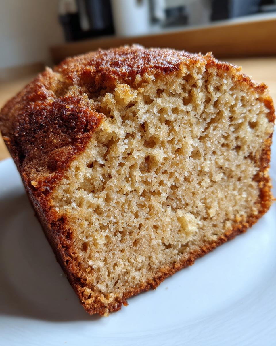 A close-up view showing the moist, airy crumb texture of a slice of cottage cheese banana bread.
