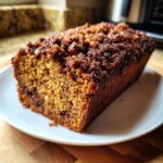 A freshly baked loaf of sweet alabama pecan bread with a dark, crumbly pecan topping.